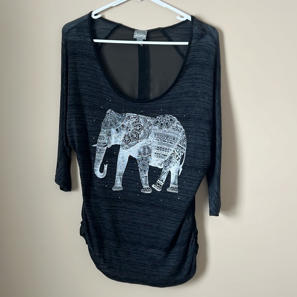 3/4 length sleeve, elephant design with sheer back with button detail